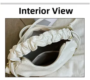 Macro shot of the interior white fish-scale bag showing the lining and zipper pocket