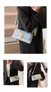 Detail showing light blue faux leather crossbody bag with elegant gold twist lock clasp