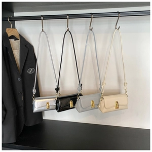 Detailed display of square crossbody bags in silver, black, gray, and beige on hooks
