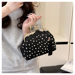 Detailed macro shot of luxury evening bag with hand-beaded pearls and floral embroidery