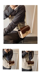 Detail view of the contrast color flap bag featuring a gold chain and metal lock closure