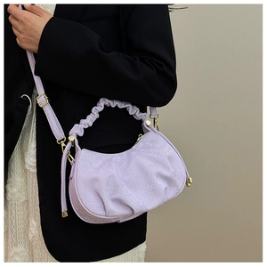 Detail of lavender pleated cloud bag with fish scale texture and gold hardware zipper