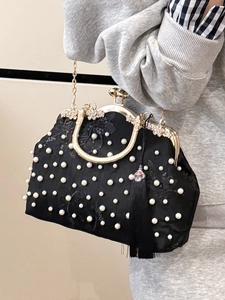 Elegant black embroidered evening bag with pearls, sequins, gold handle, and silk tassels
