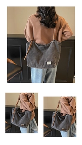 Detail view of retro grey washed denim tote bag with brown woven rope handles and metal patch