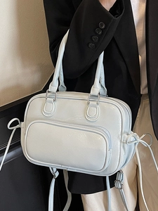 Minimalist light blue patent leather Boston bag with bow details and front zip pocket