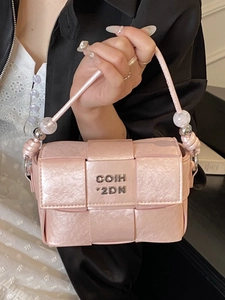 Pink woven pattern handbag with silver logo and beaded strap for elegant commuting women