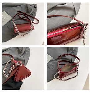 Detailed views of burgundy patent leather triangular baguette bag with silver chain strap