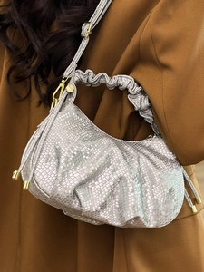Silver snakeskin textured pleated handbag with metallic finish and gold chain straps