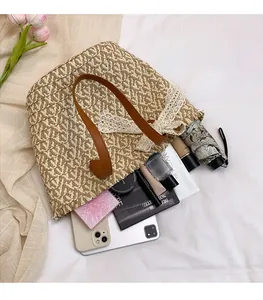 Detail of spacious straw tote bag showing internal storage capacity and lace bow