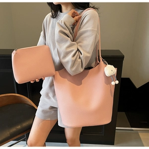 Pink lychee texture bucket bag set with cloud charm shown in a lifestyle model setting