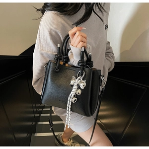 Litchi texture black bucket bag with a knot handle and decorative polka dot ribbon bow