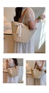 Detail view of large straw tote bag with brown leather straps and white lace bow decoration