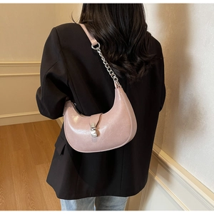 Pink crescent underarm bag with silver chain detail and sleek metal buckle clasp