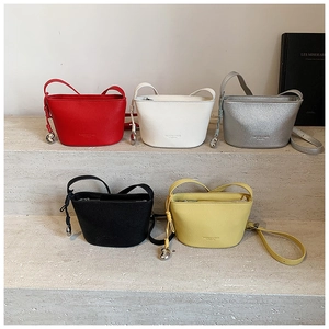 Cinque borse a secchiello minimaliste con texture litchi in vari colori su gradini