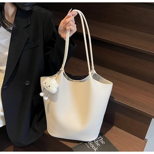 Close-up of cream lychee texture tote bag featuring a cute white cloud plush charm