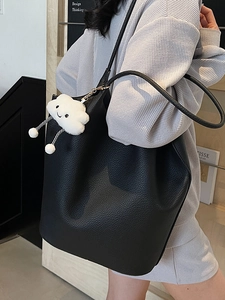 Minimalist black lychee pattern bucket bag with a cute white plush cloud charm