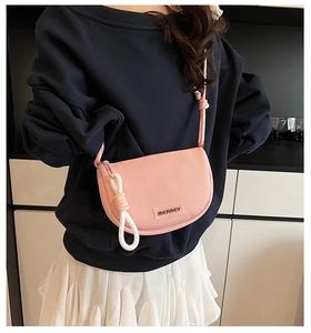 Detail view of a pink mesh crossbody bag with MERREY logo and decorative white rope knot