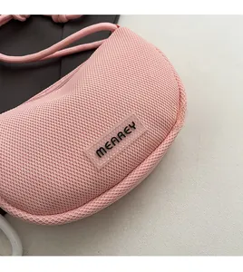 Detail shot of the pink honeycomb mesh fabric and transparent logo patch on this phone bag