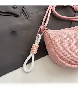 Close-up of pink mesh crossbody bag featuring durable woven rope strap and metal carabiner