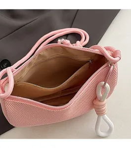 Detail view of pink mesh crossbody bag with inner zipper pocket and smooth lining