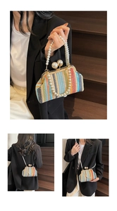 Detail of colorful rainbow woven handbag with large pearl clasp and bead handle