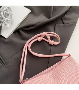 Detailed macro view of pink mesh phone bag with adjustable braided rope shoulder strap
