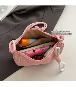 Detail of pink mesh crossbody bag showing large interior capacity for phone and wallet