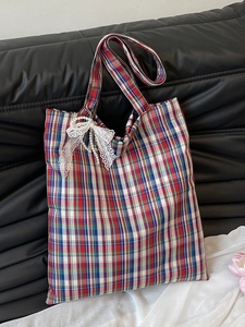 Retro plaid tote bag for women with lace bow and pearl pendant on a leather sofa