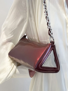 Chic dark burgundy triangular bag with patent leather finish and silver chain strap
