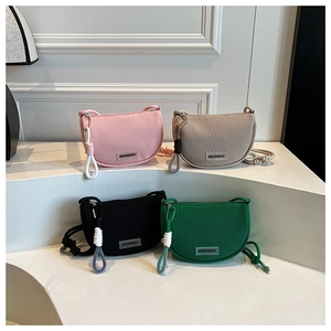 Detail view of stylish corduroy saddle bags in four colors with braided cord accents