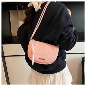 Close-up of pink mesh crossbody phone bag with white cord detail and brand label