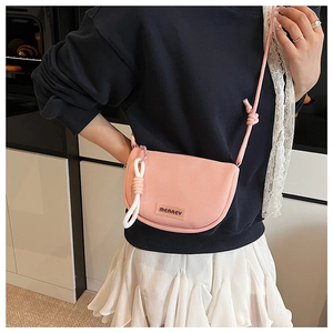 Detail of pink mesh crossbody bag featuring textured weave and MEAREY logo label