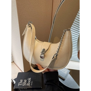 Chic cream-white crescent moon shoulder bag with silver chain strap and metal buckle closure