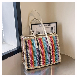 Detailed close-up of a colorful striped woven tote bag with vertical rainbow patterns