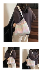 Detail of colorful striped canvas tote bag featuring adjustable strap and plush charm