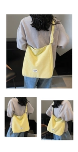 Detail of light yellow dopamine tote bag with white woven brand label and stitching