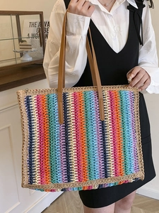 Colorful striped woven tote bag with brown shoulder straps for summer beach vacations