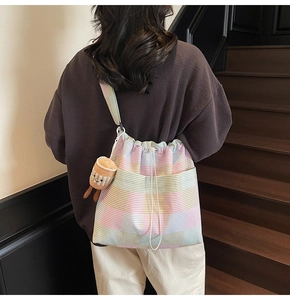 Striped canvas tote bag with drawstring and cute cup charm shown on model back view