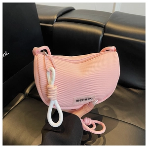 Detailed close-up of pink mesh fabric and Mearey logo on a lightweight crossbody bag