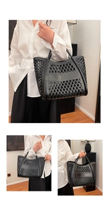 Detail of black hollow-out tote bag showing diamond mesh texture and sturdy wide handles
