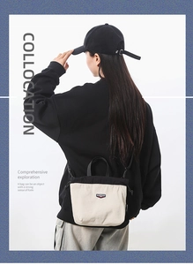Detail showing back view of the black and cream contrast drawstring canvas bag on model