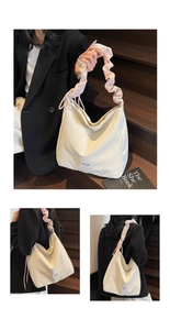 Detail of soft cream tote bag featuring pink ruffled shoulder strap and MULAIDI logo