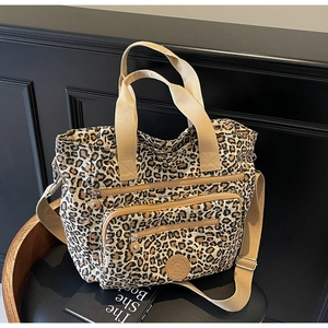 Detailed macro view of the leopard print canvas tote with front double zipper pockets
