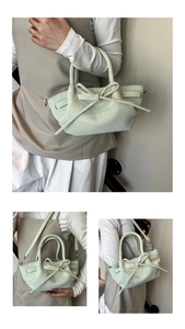 Détail d'un sac à main vert menthe en cuir avec nœud élégant et texture grainée fine