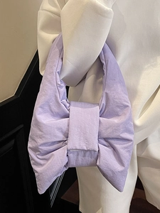 Minimalist lavender bow shoulder bag with a soft padded design and wrinkled fabric texture