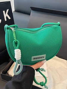 Chic green mesh crescent crossbody bag with woven strap and modern minimalist style
