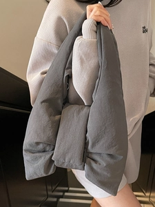 Puffy charcoal grey bow shoulder bag with padded design and minimalist aesthetic for women