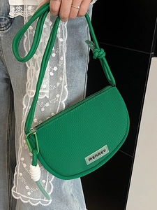 Bright green crescent mesh crossbody bag with rope strap and Merrey logo on casual model