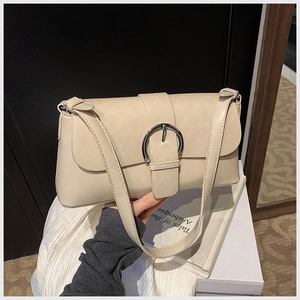 Detail of minimalist cream-white oil wax leather underarm bag with silver round buckle