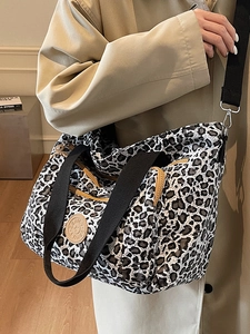 Stylish large leopard print canvas tote bag with black handles and shoulder strap